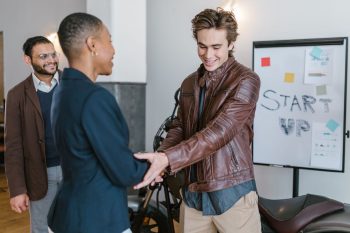 Professional young entrepreneurs shaking hands during a startup meeting indoors