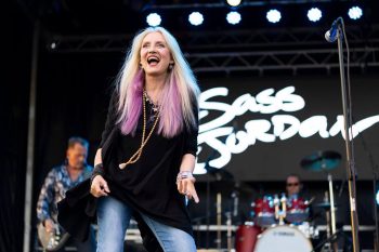Sass Jordan on stage beside a microphone stand in an archival performance photograph